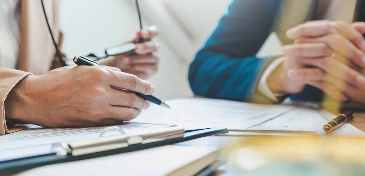 law firm at table with pens and paper
