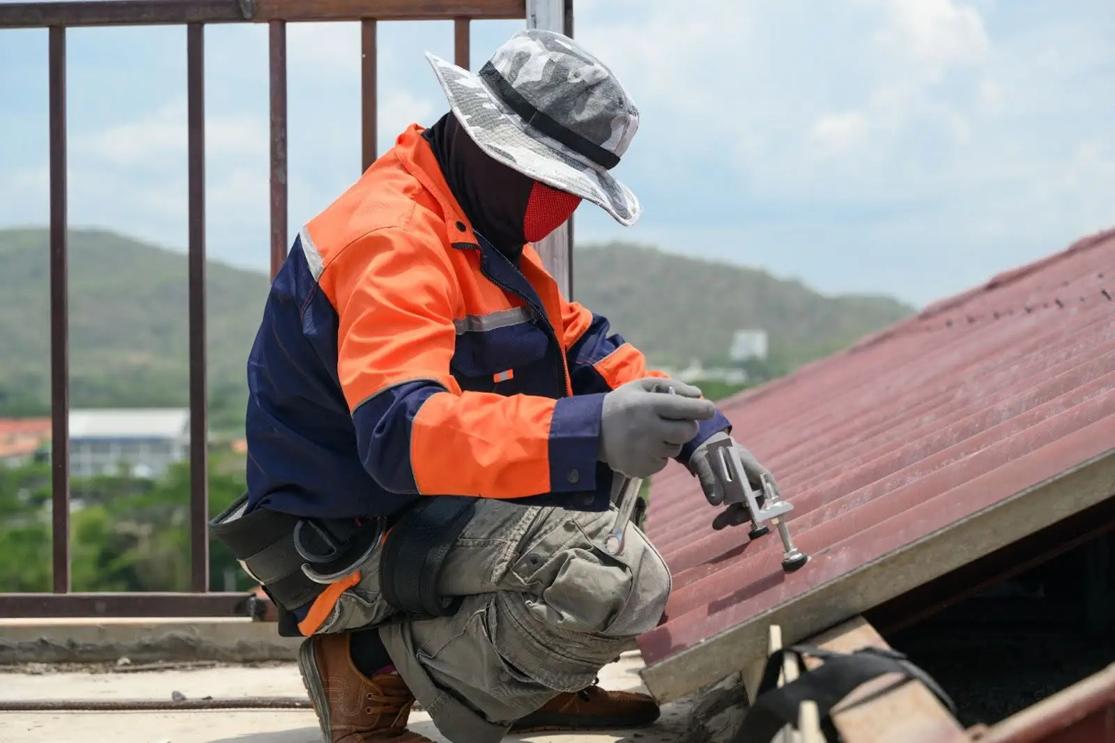 Roofing contractor inspecting metal roof during service visit related to cost per lead for roofing contractors.