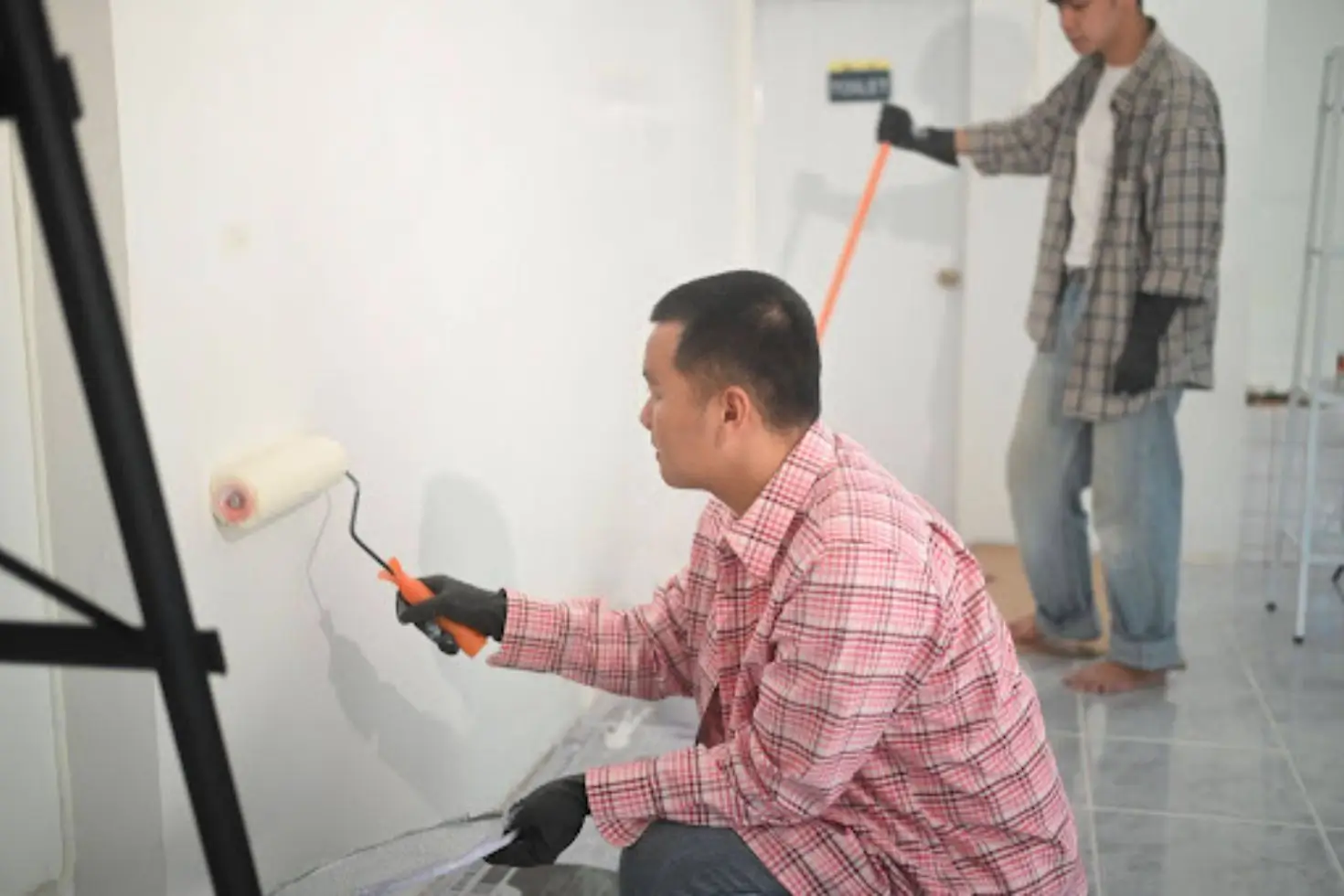 How Painting Companies Compete Without Racing to the Bottom on Price Painting Company Pricing reflects labor and preparation as painters apply fresh coats to interior walls.