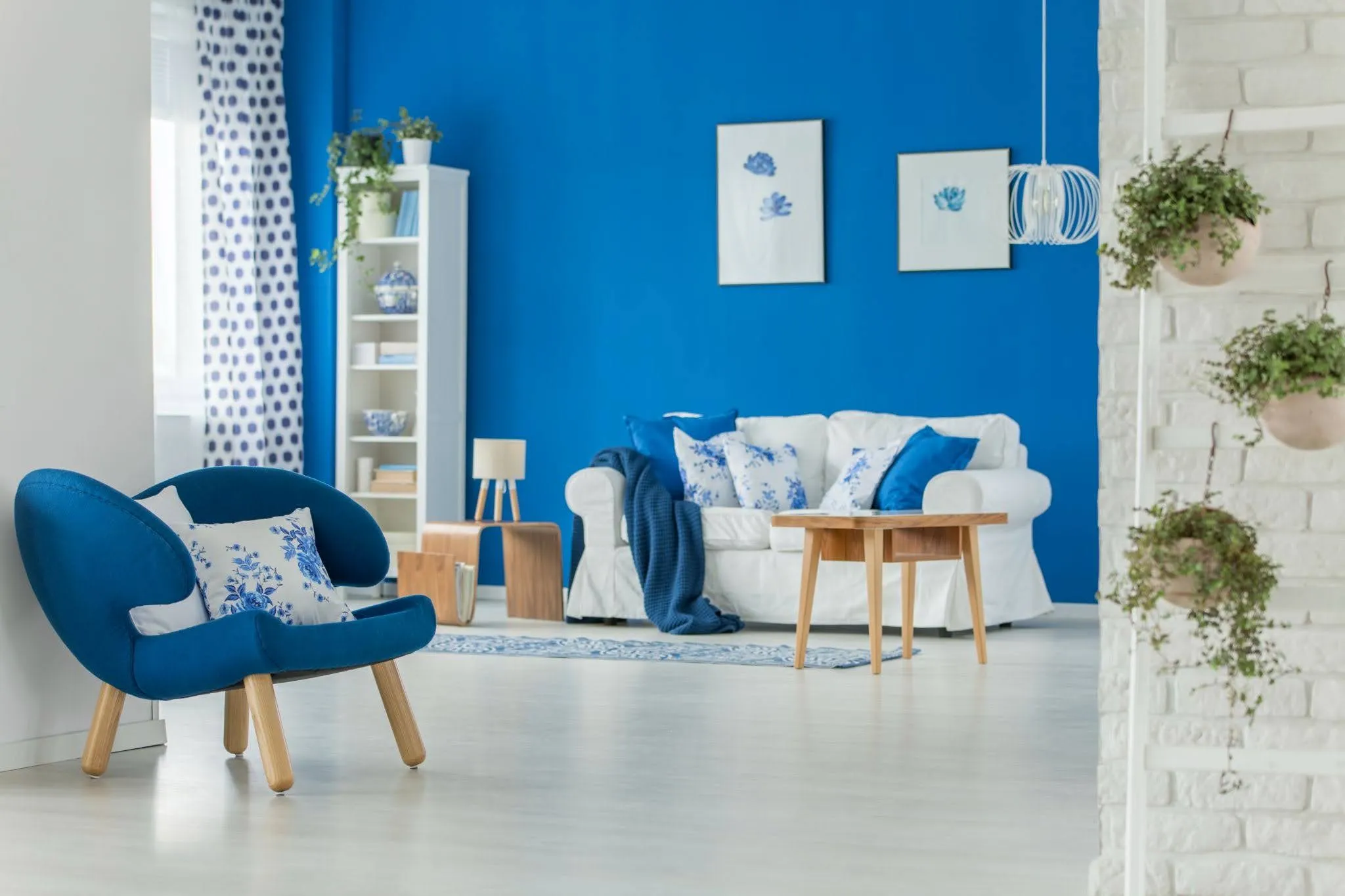 high-value-interior-painted-living-room Blue-and-white living room showcasing high-value interior painting projects with a bold accent wall and clean trim.