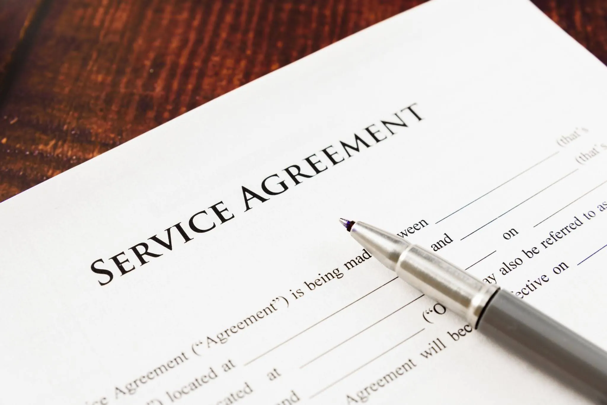 hvac-maintenance-agreements-document HVAC maintenance agreements document and pen on a wooden table, ready for customer review and signature.